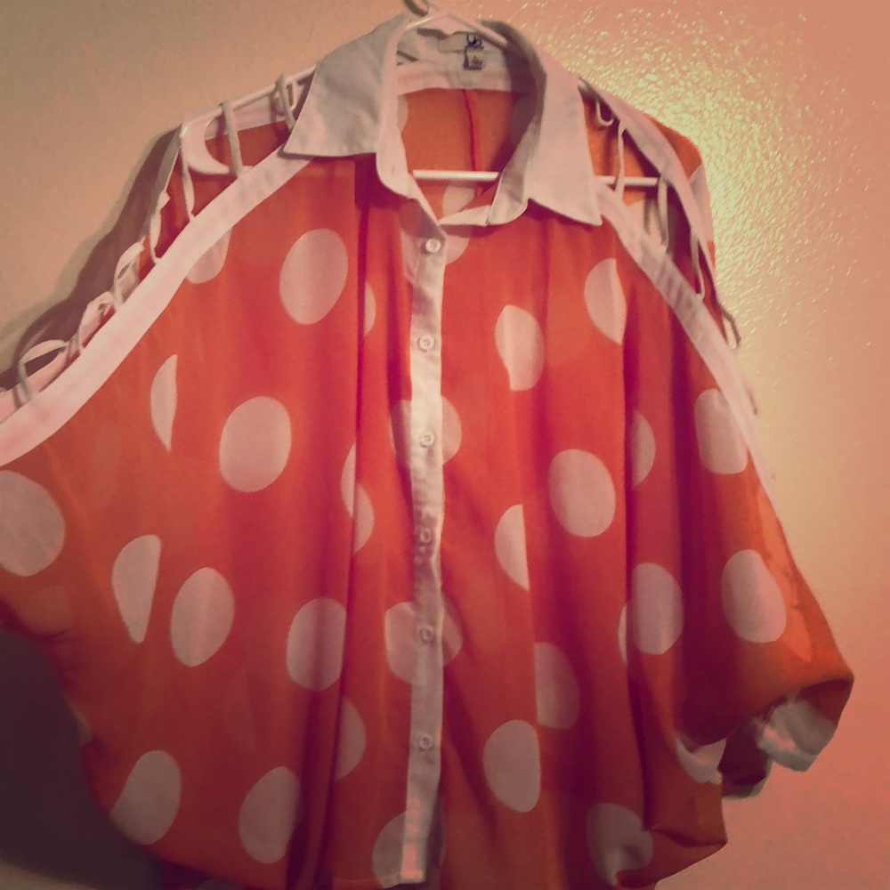 Polka dot blouse with cut out sleeves.